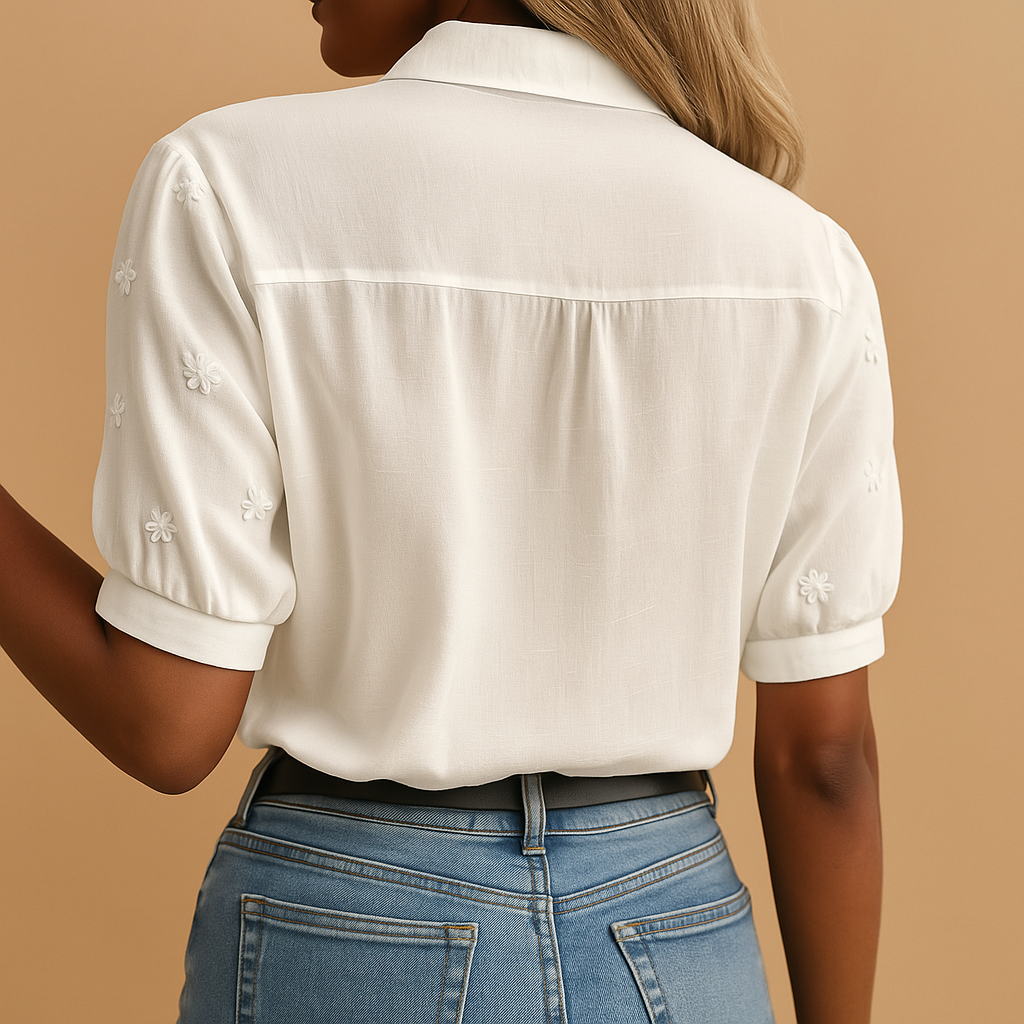 Elegant white blouse for women with a classic collar and button closure, perfect for work or casual occasions.