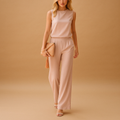 Woman wearing an elegant round-neck jumpsuit with a mid-waist fit and wide-leg design, suitable for work, evenings out, and special occasions.