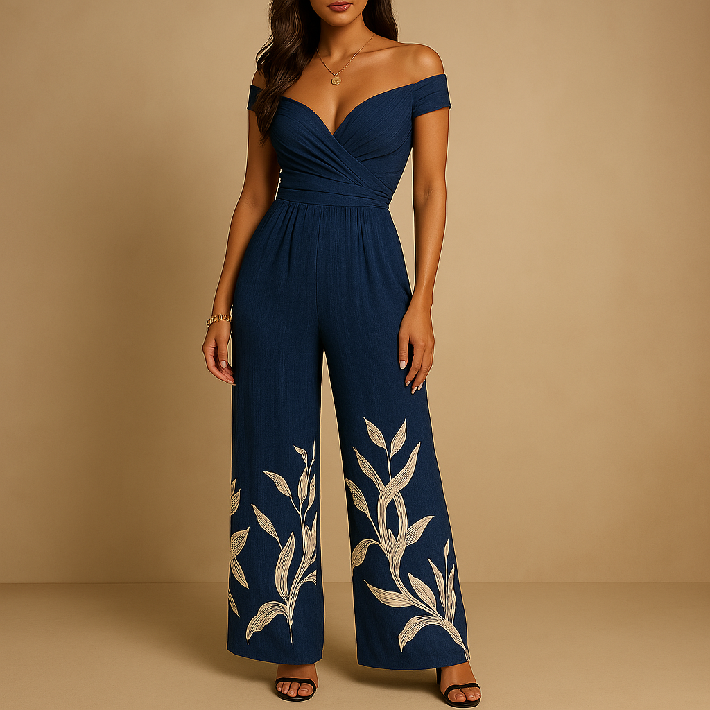 Woman wearing an off-shoulder floral jumpsuit with a tailored silhouette and blue-red print, ideal for weddings, ceremonies, and summer events.