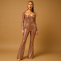 Woman wearing a shiny long-sleeve jumpsuit with a deep neckline and slim-fit legs, perfect for elegant evening events.