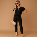 Woman wearing a tailored elegant jumpsuit with a flattering fit, suitable for business, formal dinners, and stylish evening occasions.